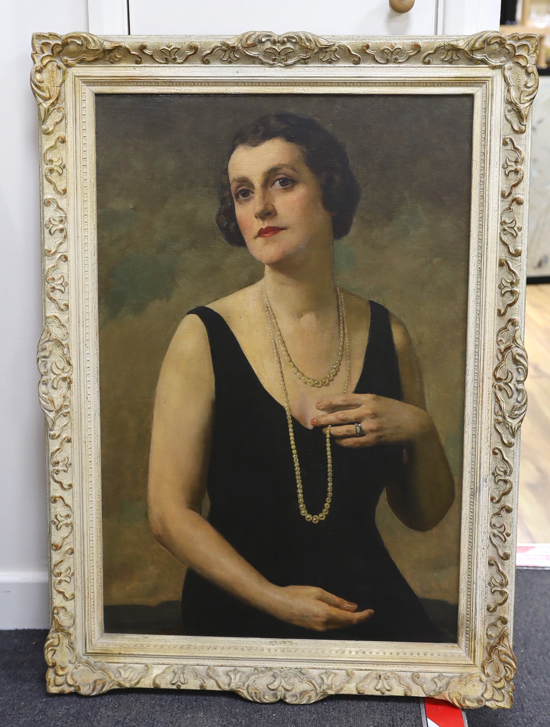 In the manner of Oswald Birley (1880-1952), early 20th century oil on canvas, Half length portrait of an Art Deco woman, unsigned, 75 x 49cm